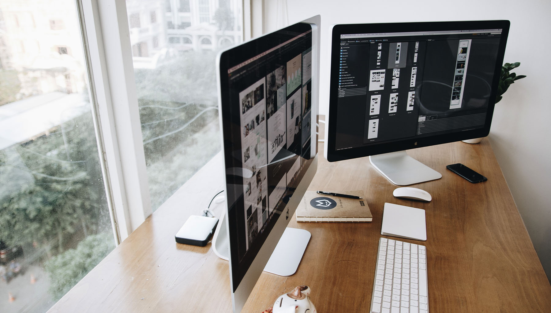 A photo of a designers desk, facing the window away from the office