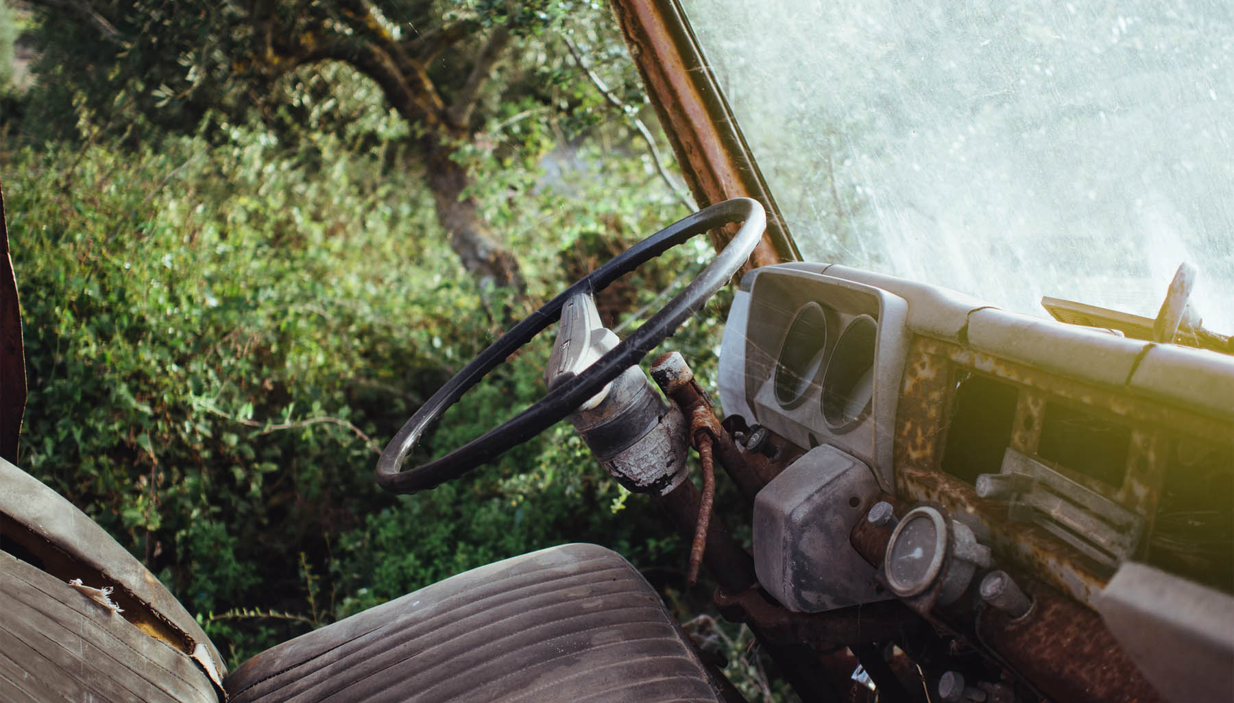 An abandoned decaying motor vehicle left to rot